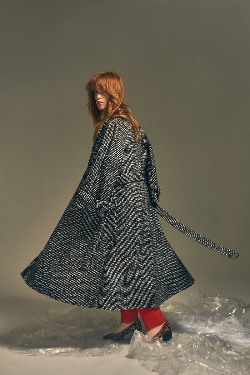 Model wearing belted houndstooth maxi coat with red trousers and leopard-print heels