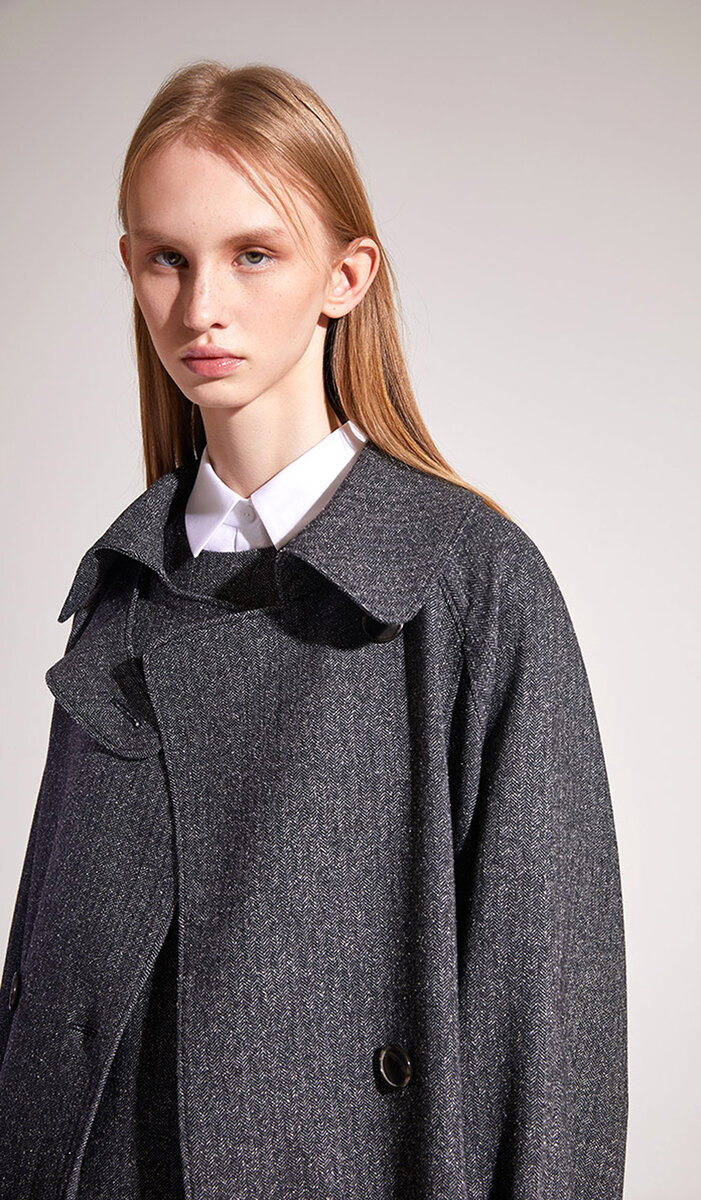 Oversized grey herringbone coat with wide ruffled collar over a white shirt